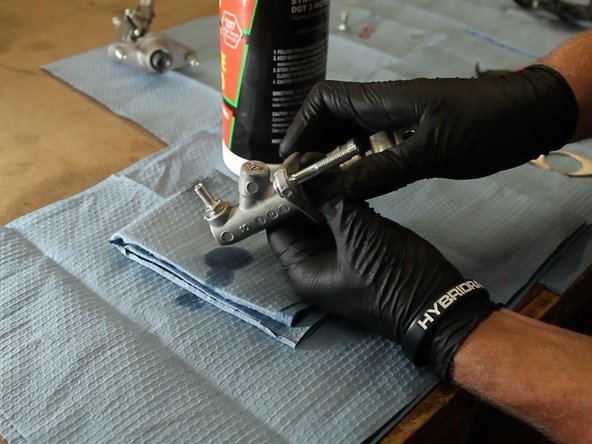 Slowly push the rod in and watch for air bubbles to come out of the fitting. The goal of this is to remove as much air from the CMC as possible. This will aid in the bleeding process.