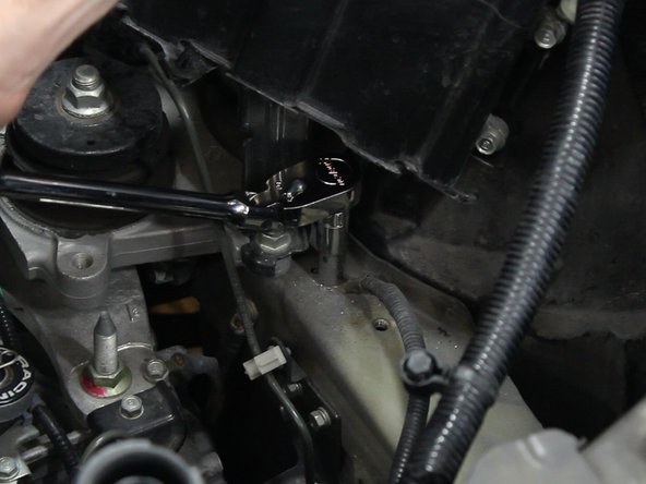 Remove the battery ground terminal from the upper frame rail.