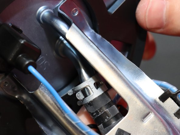 Once both clamps have been loosened, pull the pump assembly down and remove it from the cage.