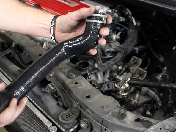 Slide the clamps onto the new upper radiator hose.