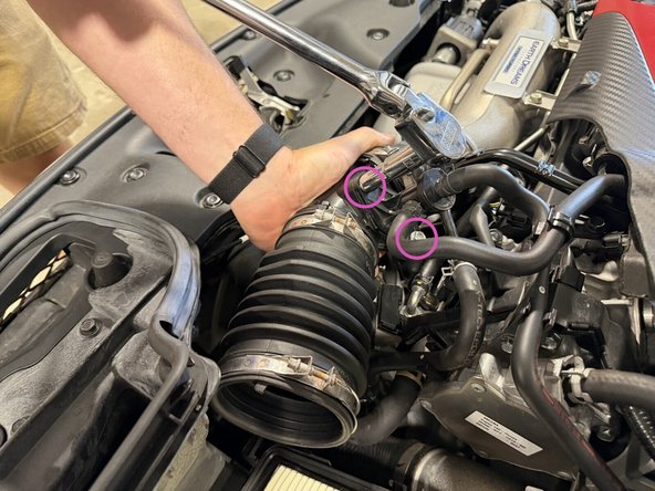 Loosen the two bolts and detach the air flow tube from the housing.