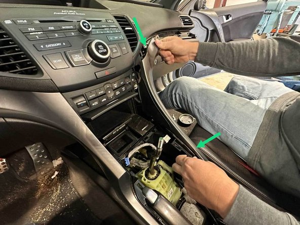 Gently pull in the locations highlighted to remove the passenger and driver side console trim.