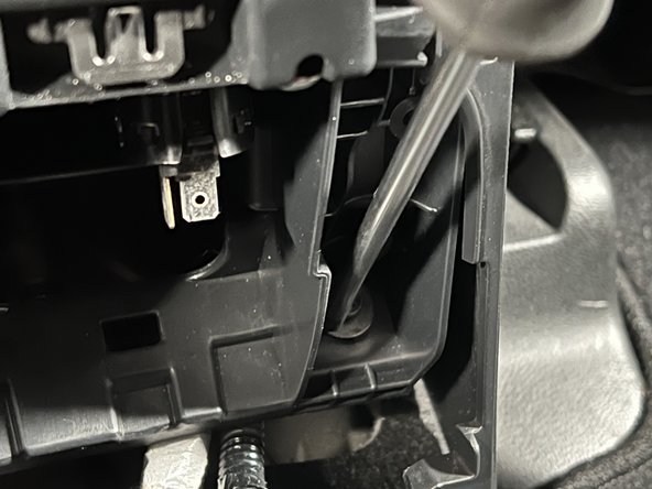 Remove the two rear mounting screws from the base of the console.
