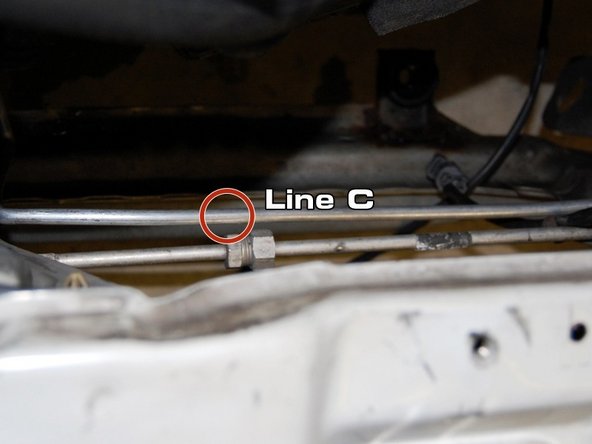Now it’s time for line C. This line comes from the bottom of the compressor to the evaporator. Bolt it to the bottom of the condenser. Make sure not to damage the O-ring, and run the line all the way to the evaporator and install with a 10 mm bolt. It runs alongside the OEM line.