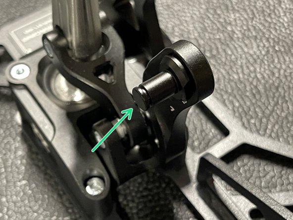 Remove the retaining pin and use a 12mm wrench to loosen the pin.