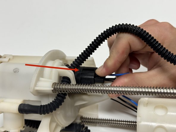 Unplug the wiring harness from the pump motor.