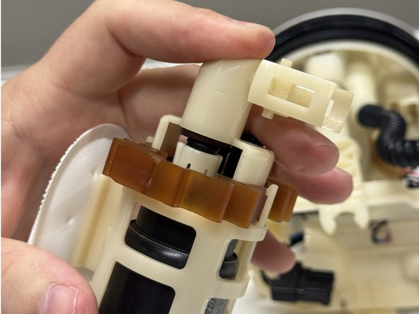 Install the new pump into the factory cage. Ensure that everything clips back together and the O-ring is securely in place.