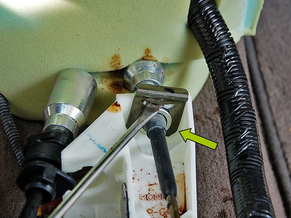 Again using the same flat head screwdriver, pry off the C-clip and slide the cable up out of the shifter.