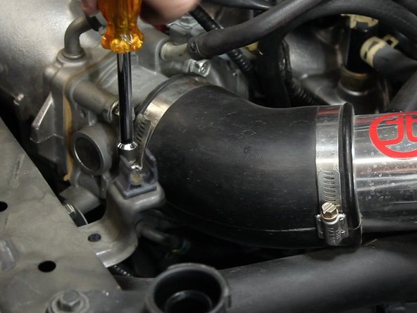 Loosen the clamp closest to the throttle body.