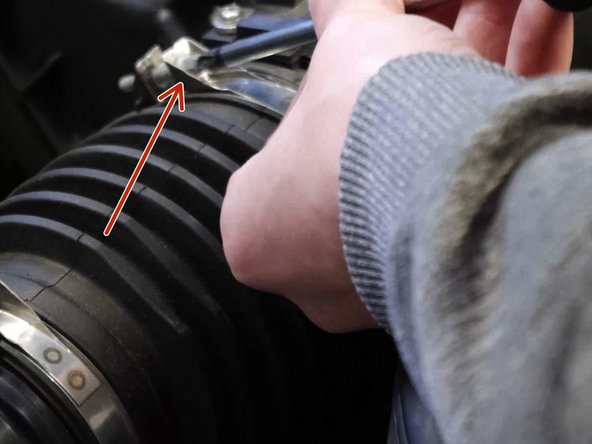 Remove the factory air intake tube clamp.