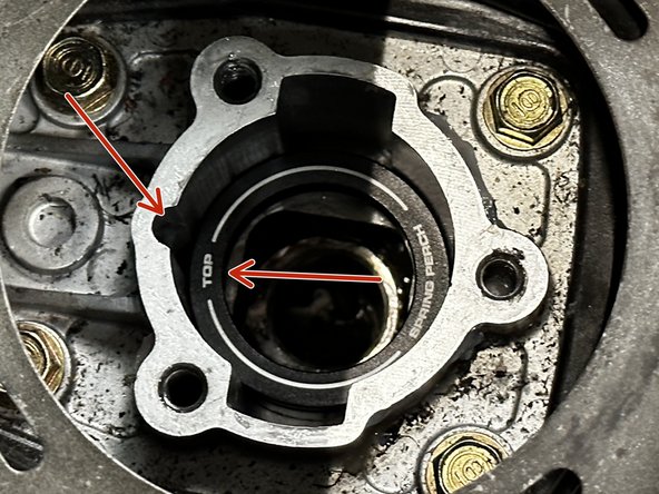 The Spring Perch is laser etched so the top side much face up. Do not install this part upside down. You can align the word TOP with the notch on the transmission.