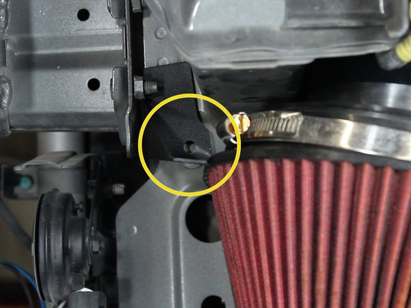 Line up the filter bracket with the threaded hole in the chassis.