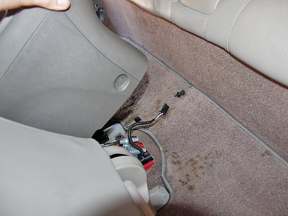 Lift up on the back side of the center console and unplug the rear aux power connector.