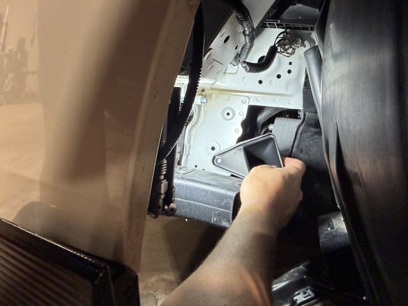 Install the lower section fully behind the bumper beam with the mounting hole pointing down. Once it's in, turn it clockwise until the hole lines up, and secure it. The push-in clip goes into the existing chassis hole.