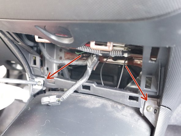 Remove the two Phillips screws that hold the front section of the console to the dash.