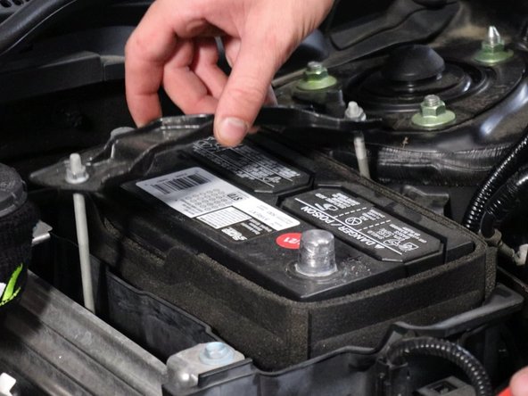 Unbolt and remove the battery tie-down bracket.