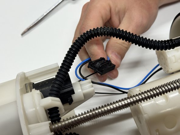 Unplug the wiring harness from the pump motor.