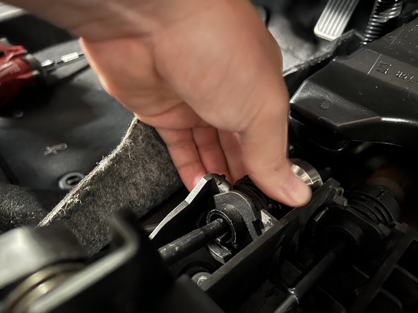 Rotate the shifter cable mount and slide it upward so it comes out of the shifter.