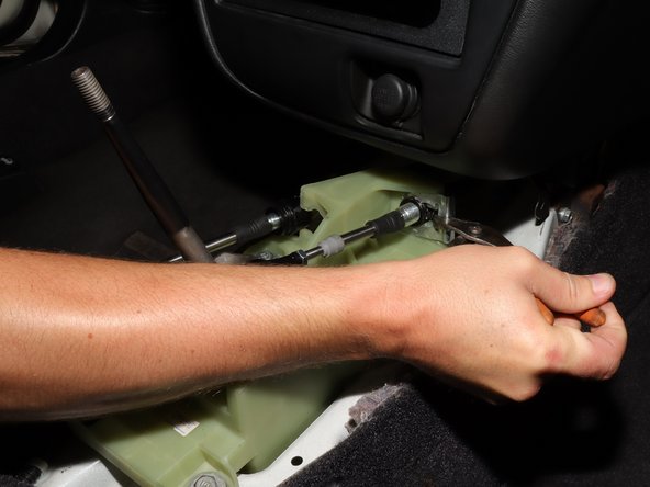 Remove the spring clip, and like the previous side, push the cable in and slide it away from the shifter.