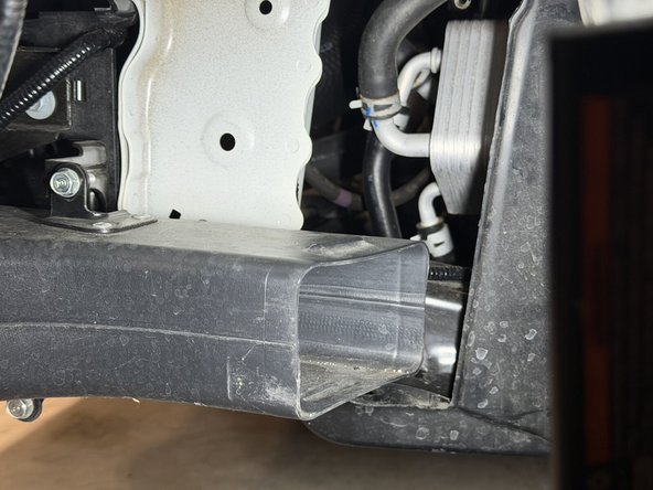 The lower air inlet mounts just above the factory brake duct.