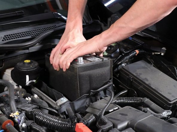 Remove the battery from the car. Then, remove the battery isolator.