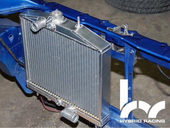 Place the radiator along with the OE rubber grommets into the factory AC location.  NOTE: The fan should be attached at this point.