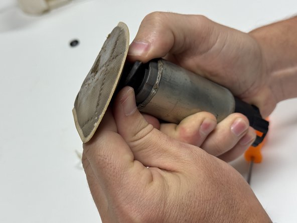 Remove the factory pump filter, retainer and lower isolator.