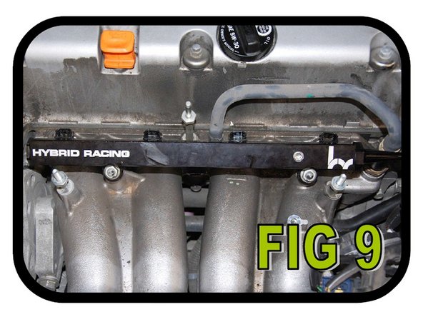 Line the injectors up with the holes on the intake manifold and press the rail onto the intake manifold. Using a 12 mm socket, install and tighten the two (2) nuts holding the fuel rail on (FIG 9).