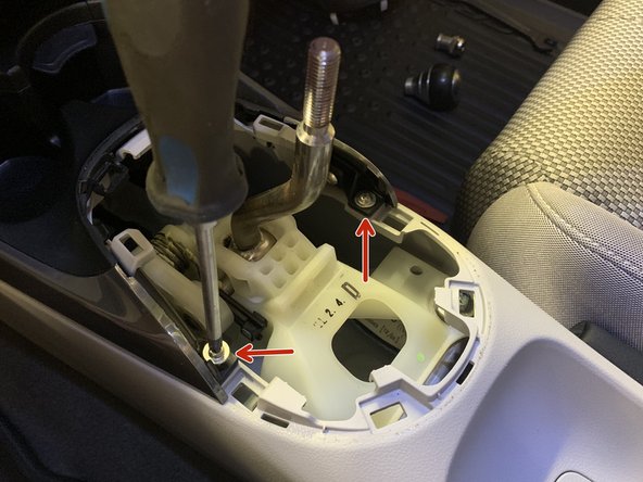 Remove the four screws holding the side trims in place.