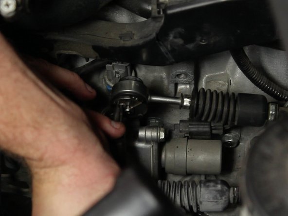 Using a pair of needle nose pliers, remove the cotter pin on the small bushing.