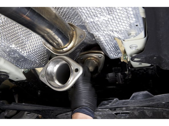 With both gaskets installed on the front pipe adapter, install it on the car. Be sure to keep the bolts loose for the time being.