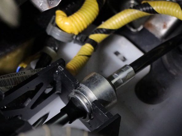 Use a flat-tip screwdriver and remove the two spring clips holding the shifter cables to the shifter.