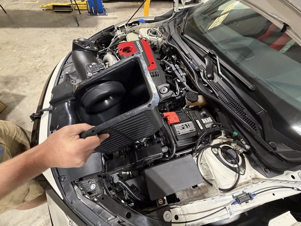 Make sure the MAF sensor wiring clears the front of the intake box as you lower it down.