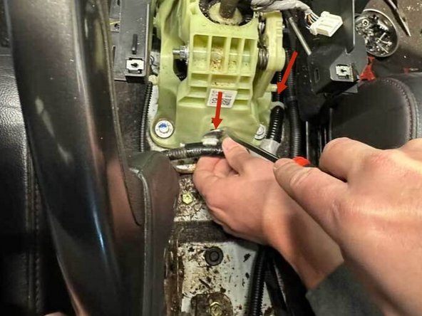 Using a panel popper, remove all of the wiring harness clips attached to the shifter plastic.