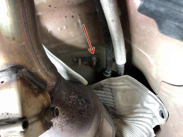 Once the heat shield is out of the way, located the 10mm nuts and bolts holding the shifter cables in place.