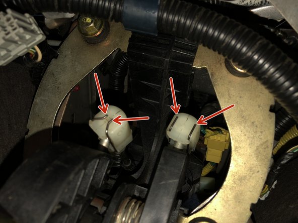 Remove the shifter cable ends from the stock shifter. The cables are held in place by metal retaining clips.