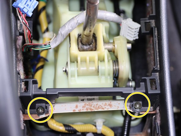 Remove the (x2) phillip screws holding the center console bracket in place.