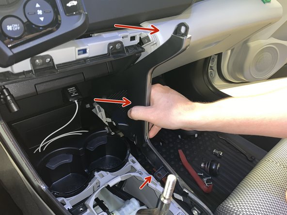 Using your hands, remove the side console trims. Once all of the screws have been removed, they just pop off.