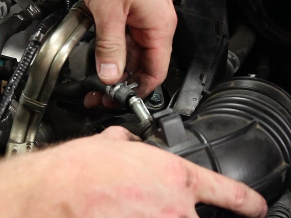 Unclamp and remove the air assist valve tube from the intake tube.