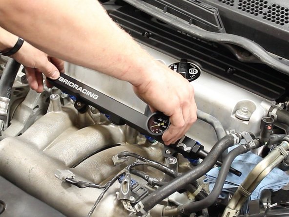 Re-install the fuel rail with the new injectors. Evenly push on the fuel rail to insure you evenly seat the injectors into the intake manifold.