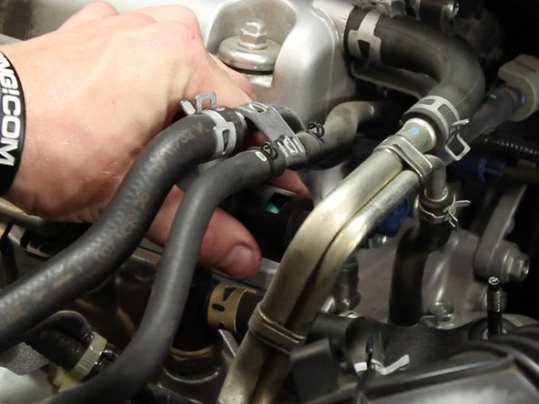 Remove the quick disconnect fuel fitting cover from the fuel rail connection.