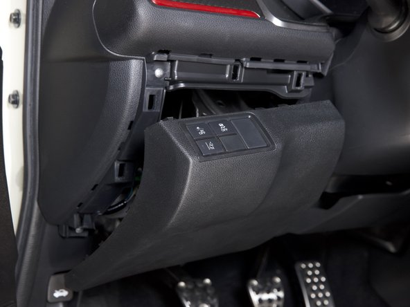 Pull outward on the bottom section of the lower dash panel. It should pop outward allowing you clear access to the fuse box and grounding location.