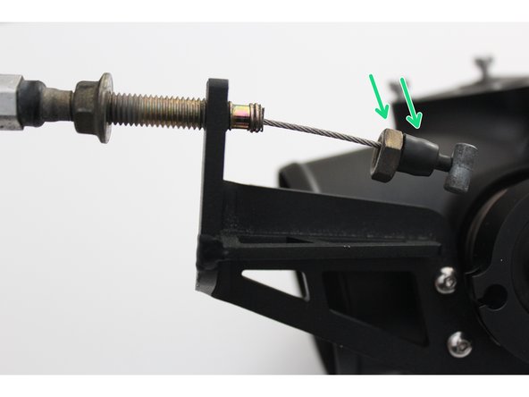 Begin by threading one of mounting nuts and rubber boot down towards the end of the cable. Insert the throttle cable through the bracket groove.