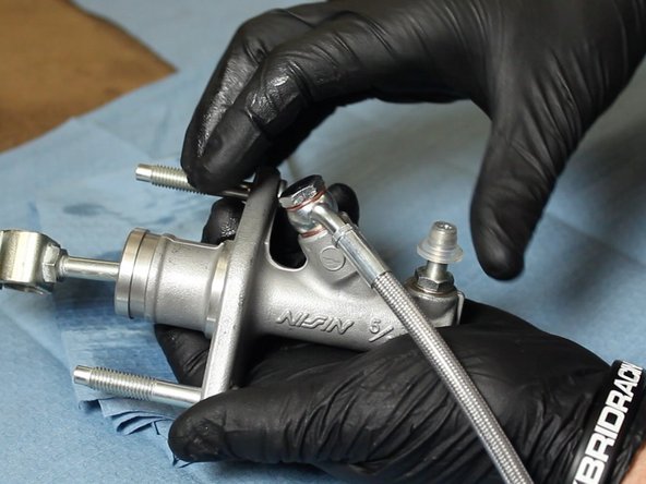 Install the clutch line with the banjo fitting pointing away from the CMC mounting flange.