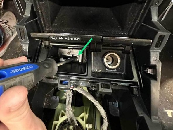 Remove the lone Phillips screw hidden in the pocket floor.