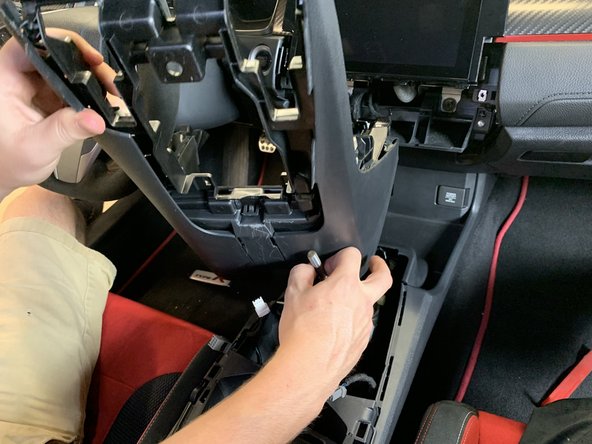 You may need to put your shifter into 4th gear to clear the plastic cover.