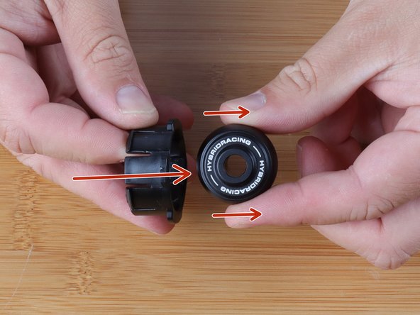 Use your fingers and rotate the center bushing so that it aligns with the large portions of the delrin ring.