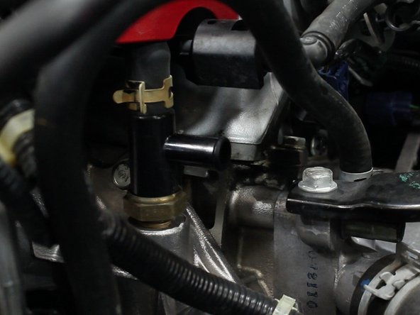 Use plies to remove the hose clamp and then remove the factory hose.