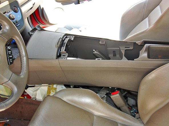 Remove the center console and place it in the back seat.