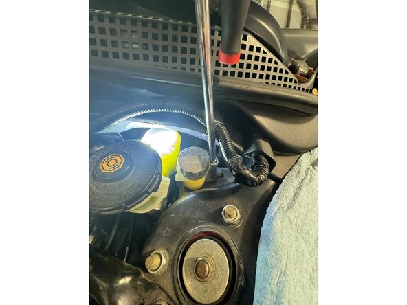 The reservoir hose does not need to be removed from CMC yet. As you will see in later steps, the CMC and Reservoir and be pulled out together.